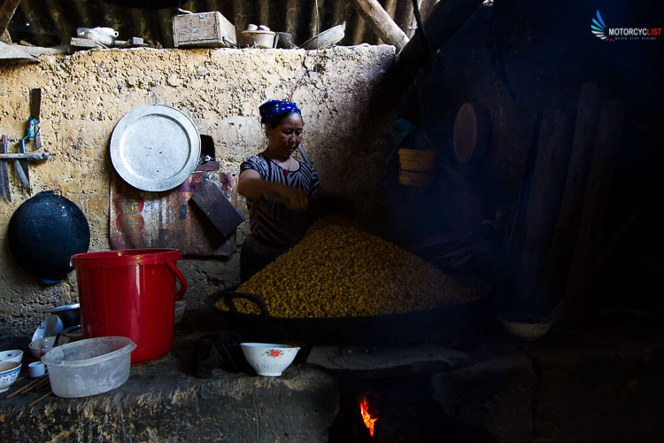 Lady distilling liquor from corn in Bac Ha, Vietnam